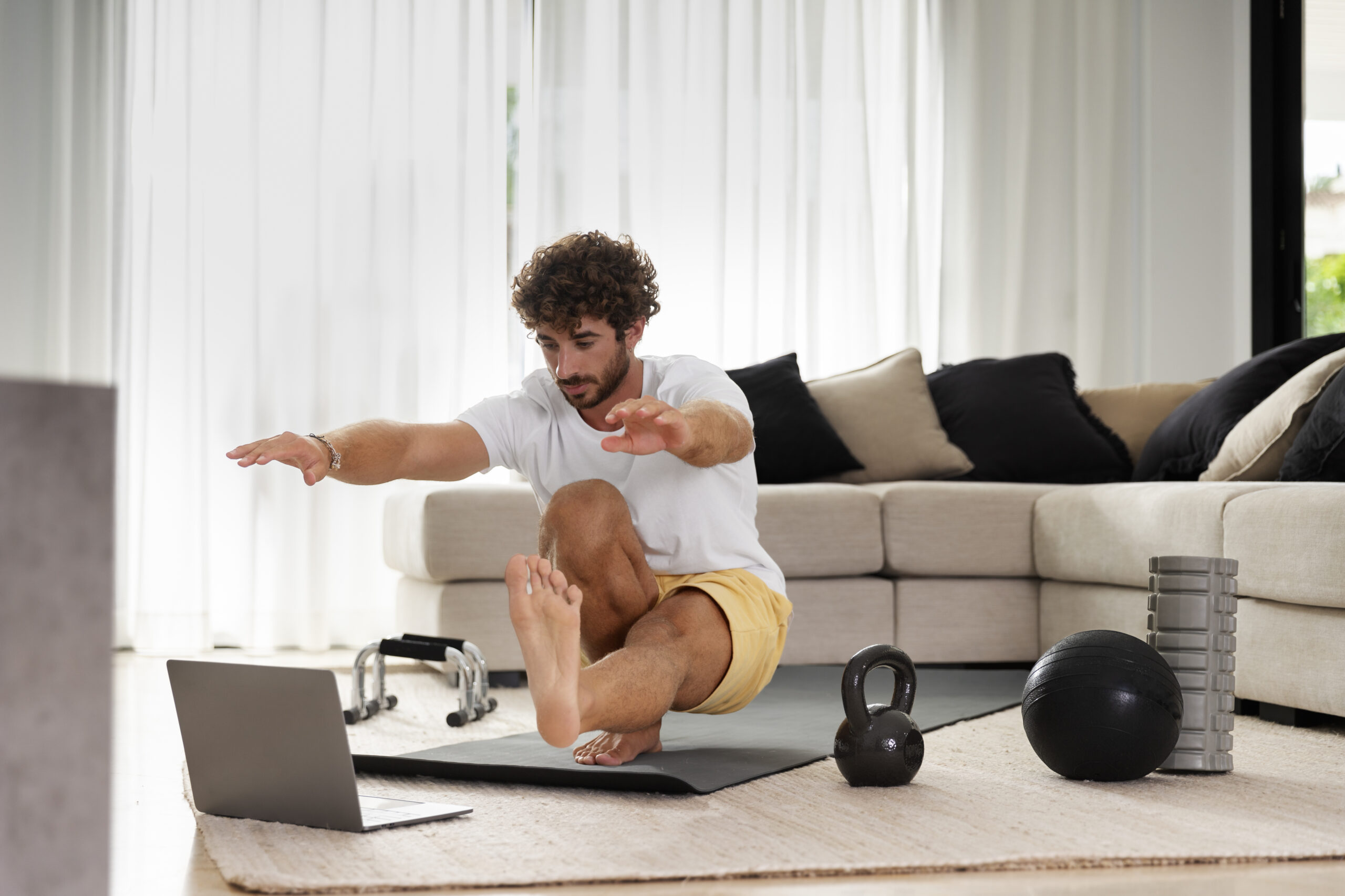 “Man doing beginner exercise routine at home without equipment in living room”